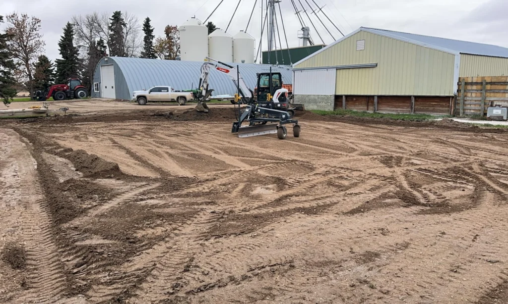 Small backhoe on farm digging